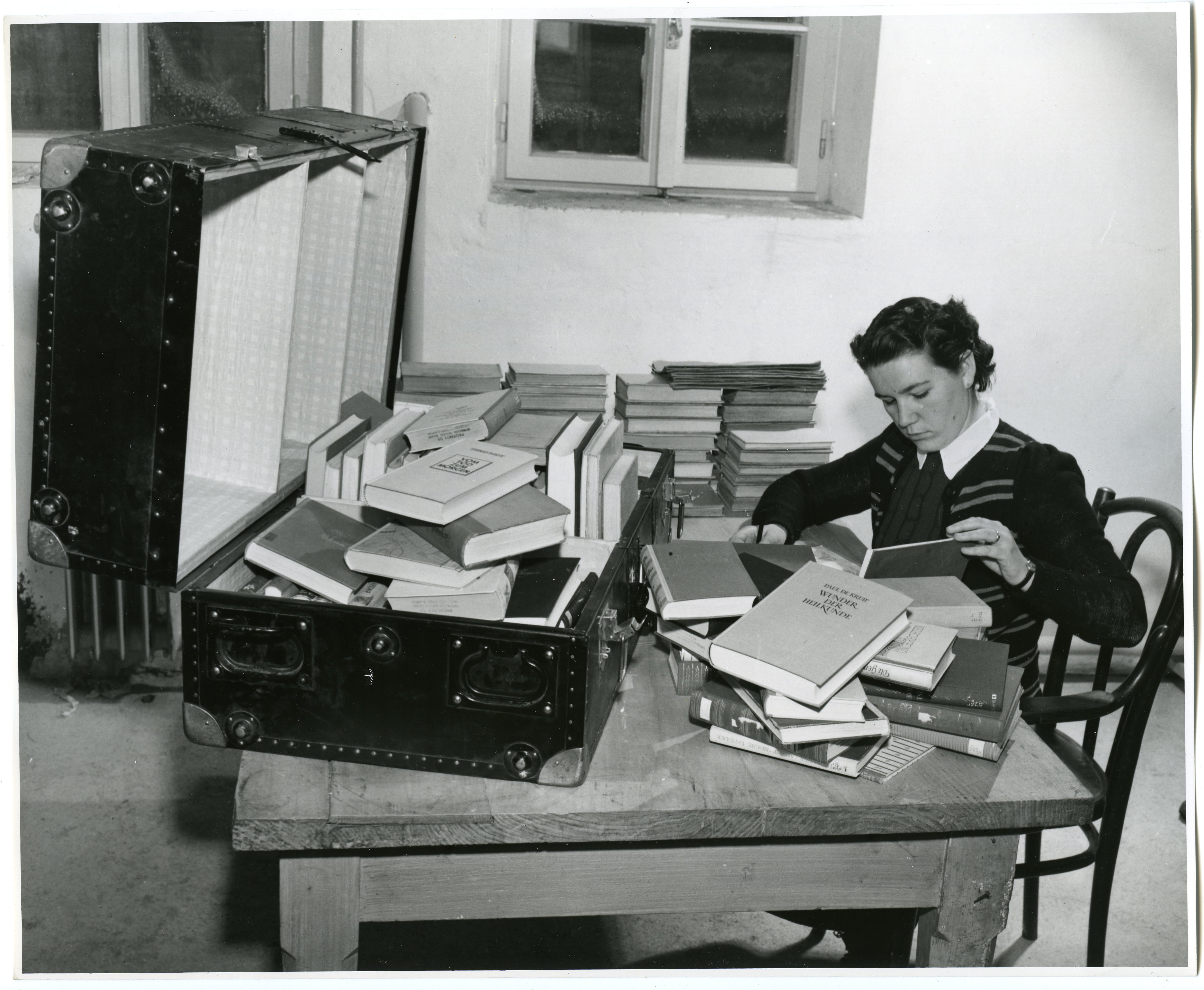 Original Caption: The Librarian Carefully Enters the Consignment Into Her Books, 12/1952. Records of the U.S. Information Agency. National Archives Identifier 23932351