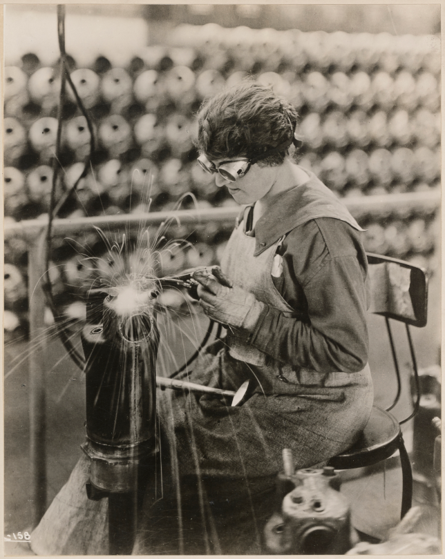 Liberty motors manufactured for government use. Electric welding on the steel jacket on a Liberty Motor cylinder. Lincoln Motor Co. plant. Detroit, Michigan. National Archives Identifier 45567610