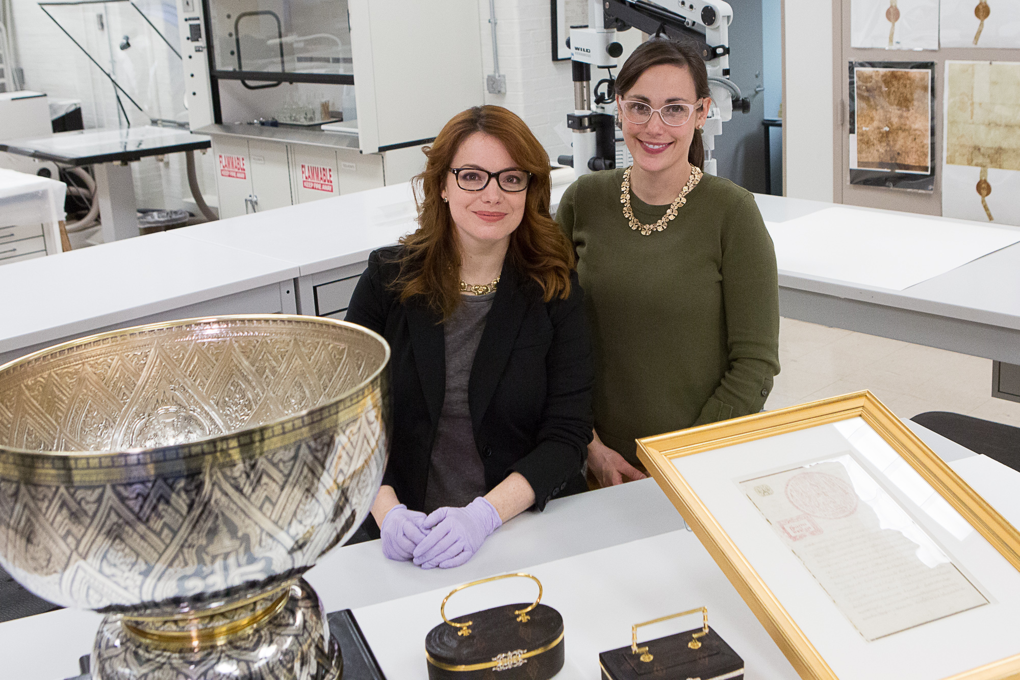 National Archives supervisory conservator Abigail Aldrich and senior conservator Lauren Varga share several items including a silver niello bowl